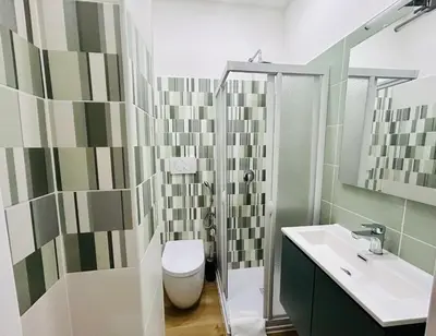 a bathroom with a toilet and a sink and a shower at Segesta Rooms in Rome