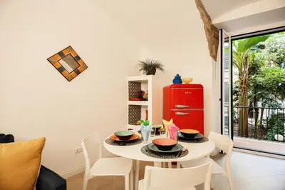 a dining room with a table and chairs and a red cabinet at HC - Chez Le Roi Luxury Apartment in Rome