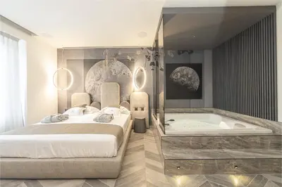 a bedroom with a bed and a bath tub at Tritone Luxury Suites Piazza del Popolo in Rome