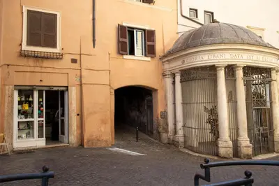 an entrance to a building with a building with a gate at Costaguti Holiday Apartment in Rome