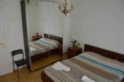 a bedroom with two beds and a mirror at Apartment Veio in Rome