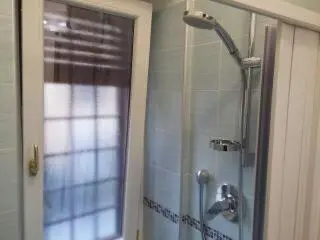 a shower in a bathroom with a glass door at Apartment Veio in Rome