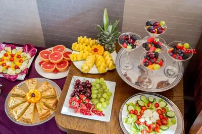 a table with many plates of fruit and wine glasses at The Inn at the Spanish Steps Luxury Collection - Spanish Step Suites in Rome