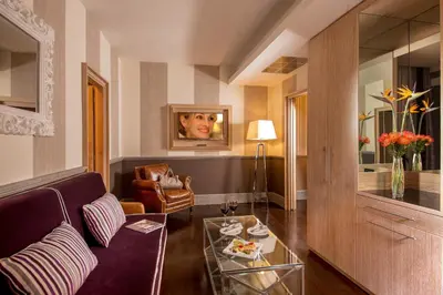a living room with a couch and a table at The Inn at the Spanish Steps Luxury Collection - Spanish Step Suites in Rome