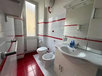 a white bathroom with a toilet and a sink at ROMA Appia in Rome