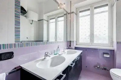 a bathroom with a sink and a toilet and a window at BDC - Rome, Open City! 3-BDR! in Rome