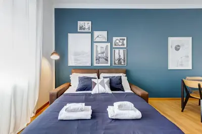 a blue bedroom with a large bed with towels on it at BDC - Rome, Open City! 3-BDR! in Rome