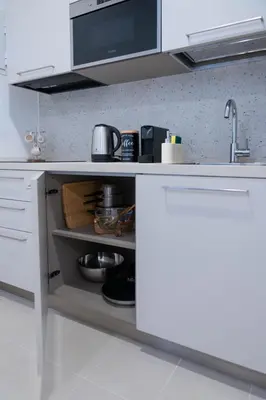 a kitchen with white cabinets and a counter top at When in Rome in Rome