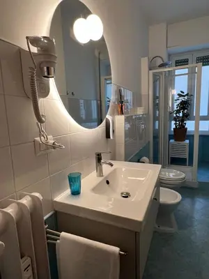 a bathroom with a sink and a mirror at Maison Roberto in Rome