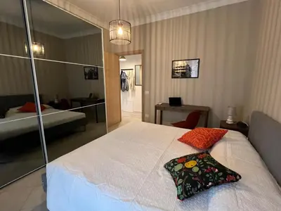 a bedroom with a white bed with a pillow on it at Maison Roberto in Rome