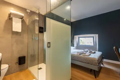 a bathroom with a bed and a glass shower at LUMINA3 Luxury Room ROME in Rome