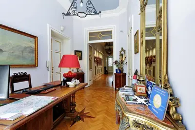 a room with a desk and a table with a lamp at Domus Monamì Luxury Suites in Rome