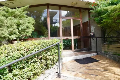 a house with a glass door and some bushes at Villa Bonelli Penthouse in Rome