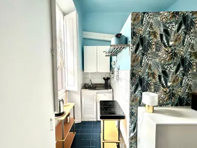 a small kitchen with blue walls and a sink at Pina Charme in Rome