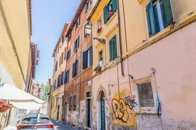 a building with graffiti on the side of a street at Sweet home Trastevere 2- Roma in Rome