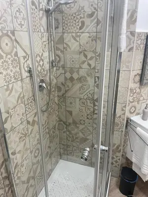 a shower with a glass door in a bathroom at Sweet home Trastevere 2- Roma in Rome