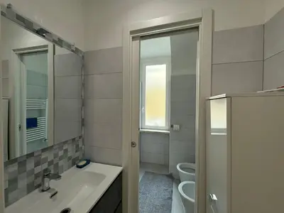a bathroom with a sink and a toilet and a mirror at Quiet Corner in the Eternal City in Rome