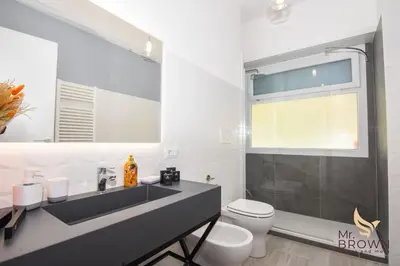 a bathroom with a sink and a toilet and a shower at Orange House in Rome