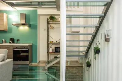 a staircase in a living room with a glass floor at Casa Cristallo Relax e Spa in Rome