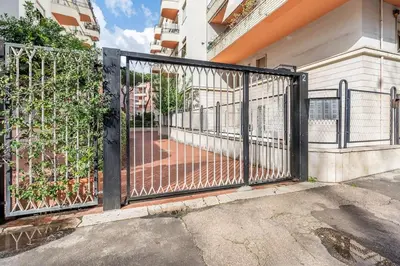 a black metal gate in front of a building at Vatican Penthouse 1 by Almond Tree in Rome