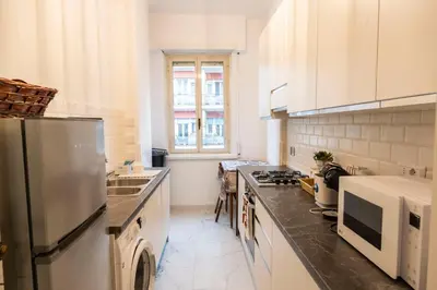 a kitchen with a refrigerator and a sink at archi gianicolensi apartment in Rome