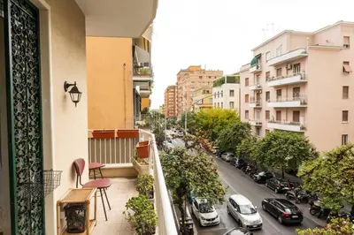 a balcony with a view of a city street with cars at archi gianicolensi apartment in Rome
