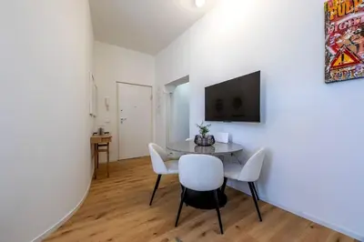 a living room with a white couch and a window at Properzio 37 in Rome