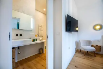 a bedroom with a bed and a chair and a window at Properzio 37 in Rome