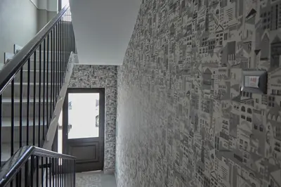 a hallway with a wall covered in stickers at Bivio - Casa Verde in Rome