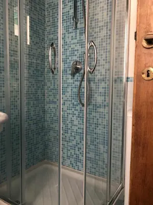 a bathroom with a shower with glass doors at Appartamento familiare nel cuore di Roma in Rome