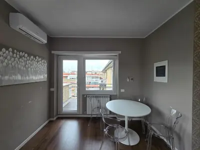 a dining room with a table and chairs and a window at Domus Paolina Ostiense in Rome