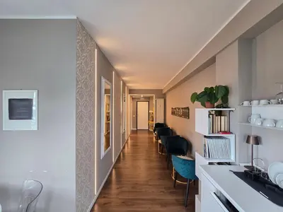 a hallway leading to a living room with chairs at Domus Paolina Ostiense in Rome