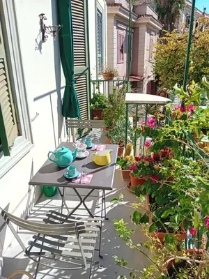 a table and chairs on a patio with flowers at Bed & Breakfast da Monica in Rome
