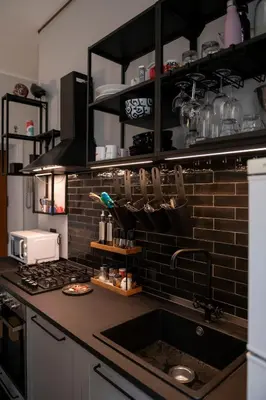 a kitchen counter with a sink and a stove at Artist Vatican House in Rome