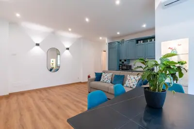 a living room with a table and a couch at Vatican Oasis - Free Parking, 4-6 pax, 2 bedrooms in Rome