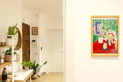 a living room with a painting on the wall at Luminosa camera con bagno privato interno - vicina alla metro in Rome