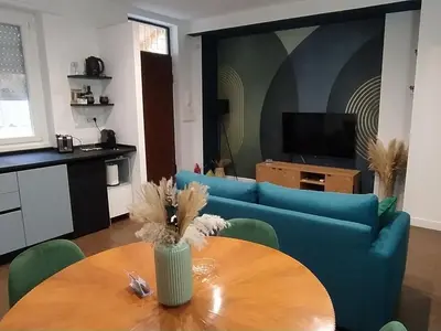 a living room with a blue couch and a table at A casa di Piero in Rome