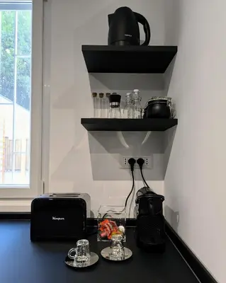 a black counter with a toaster and a toaster and a toaster at A casa di Piero in Rome