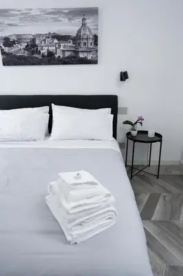 a white bed with a towel on top of it at F House Trastevere in Rome