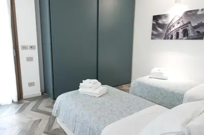 a room with two beds and a picture of a building at F House Trastevere in Rome
