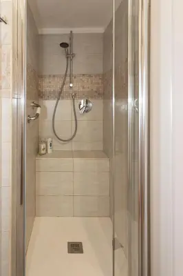 a shower with a glass door in a bathroom at Marisa lovely house in Rome