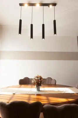 a large wooden table with a vase of flowers on it at Marisa lovely house in Rome
