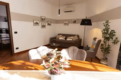 a living room with a table and chairs and a couch at Marisa lovely house in Rome