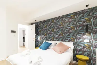 a bedroom with a large floral wall mural at GENESI Suites in Rome