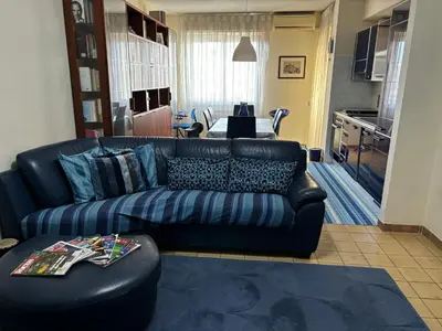 a living room with a couch and a painting on the wall at GrElly's House - Holiday in Rome - 50 meters from the Metro in Rome