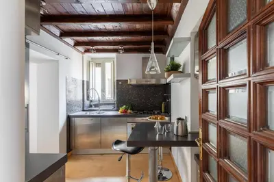 a kitchen with wooden cabinets and a counter top at iFlat Trevi's Paradise in Rome