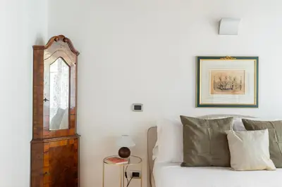 a living room with a white couch and a mirror at iFlat Trevi's Paradise in Rome