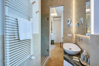 a bathroom with a sink and a mirror at Green Tevere Rooftop in Rome