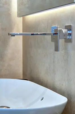 a bathroom with a white sink and a mirror at Green Tevere Rooftop in Rome