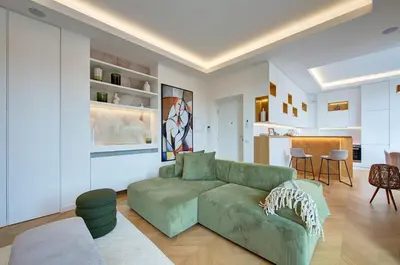 a living room with a green couch and a kitchen at Green Tevere Rooftop in Rome